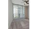 Bright bedroom featuring sliding glass doors, a ceiling fan, and neutral carpet flooring at 1120 E Kennedy Blvd # 1523, Tampa, FL 33602