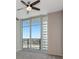 Bright bedroom featuring sliding glass doors to a balcony and a ceiling fan at 1120 E Kennedy Blvd # 1523, Tampa, FL 33602
