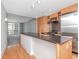 Modern kitchen with sleek wooden cabinets, stainless steel appliances, and a large granite island at 1120 E Kennedy Blvd # 1523, Tampa, FL 33602
