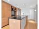 Modern kitchen featuring a large island, stainless steel appliances, and light wood cabinets at 1120 E Kennedy Blvd # 1523, Tampa, FL 33602