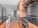 Gourmet kitchen with stainless steel appliances, granite counters, and hardwood floors at 1120 E Kennedy Blvd # 1523, Tampa, FL 33602