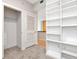Walk-in closet with adjustable shelving, a door, and carpeted floor at 1120 E Kennedy Blvd # 1523, Tampa, FL 33602