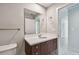 Contemporary bathroom with a wood vanity, white countertop, and a large mirror at 1208 E Kennedy Blvd # 1115, Tampa, FL 33602