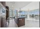 Chef's kitchen with stainless steel appliances and floor-to-ceiling windows overlooking the cityscape at 1208 E Kennedy Blvd # 1115, Tampa, FL 33602