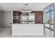 Contemporary kitchen boasts stainless steel appliances, dark wood cabinets, and plenty of light from a view-filled window at 1208 E Kennedy Blvd # 1115, Tampa, FL 33602