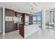 Modern kitchen features dark wood cabinets, stainless steel appliances, island and a bright view from large windows at 1208 E Kennedy Blvd # 1115, Tampa, FL 33602