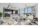 Airy, open-concept living space featuring modern kitchen, dining area, and seating with city views through large windows at 1208 E Kennedy Blvd # 1115, Tampa, FL 33602