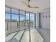 Bright living space featuring expansive windows with stunning views, a modern ceiling fan, and sleek pendant lights at 1208 E Kennedy Blvd # 1115, Tampa, FL 33602