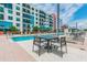 Relaxing community pool area with lounge chairs, table seating, and lush landscaping at 1208 E Kennedy Blvd # 1115, Tampa, FL 33602