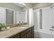 A bathroom featuring a vanity with granite countertop, a shower-tub combination, and neutral tile at 12326 Terracina Chase Ct, Tampa, FL 33625