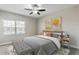 Inviting bedroom with neutral walls, stylish decor, a ceiling fan, and a bench at 12326 Terracina Chase Ct, Tampa, FL 33625