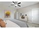 A bright bedroom with neutral walls and a ceiling fan features stylish decor at 12326 Terracina Chase Ct, Tampa, FL 33625