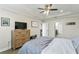 Well-lit bedroom featuring a tray ceiling and ample closet space with easy access to the en-suite bathroom at 12326 Terracina Chase Ct, Tampa, FL 33625