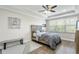 Comfortable bedroom with tray ceilings, ample natural light, and neutral decor, creating a relaxing retreat at 12326 Terracina Chase Ct, Tampa, FL 33625
