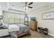 Bright bedroom featuring tray ceilings, generous natural light, and a calming neutral palette, promoting relaxation at 12326 Terracina Chase Ct, Tampa, FL 33625