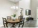 Cozy dining area with a wooden table set, chandelier lighting, and a view into the adjacent living room at 12326 Terracina Chase Ct, Tampa, FL 33625