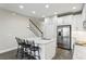 Bright kitchen features a large island with barstool seating, modern countertops and stainless steel refrigerator at 12326 Terracina Chase Ct, Tampa, FL 33625