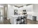 Bright kitchen with white cabinets, stainless steel appliances, and a center island with bar stool seating at 12326 Terracina Chase Ct, Tampa, FL 33625