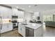Modern kitchen boasts stainless steel appliances, a center island, and an open view to the dining and living areas at 12326 Terracina Chase Ct, Tampa, FL 33625