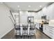 Elegant kitchen showcases white cabinets, stainless appliances, and a convenient island with bar stool seating at 12326 Terracina Chase Ct, Tampa, FL 33625