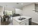 Open concept kitchen featuring a center island, stainless steel appliances, and a view of the dining and living areas at 12326 Terracina Chase Ct, Tampa, FL 33625