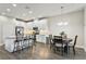 Contemporary kitchen with stainless appliances, white cabinetry, island seating, and open dining area at 12326 Terracina Chase Ct, Tampa, FL 33625
