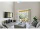 Inviting living area with comfortable seating, a view of the outdoor patio, and a modern entertainment setup at 12326 Terracina Chase Ct, Tampa, FL 33625