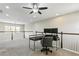Spacious loft area featuring neutral carpet, bright natural light, and a ceiling fan for comfortable living at 12326 Terracina Chase Ct, Tampa, FL 33625