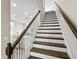 A staircase with white risers and dark wood treads leads to the second floor, blending classic design with modern openness at 12326 Terracina Chase Ct, Tampa, FL 33625