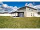 Large backyard showcasing a covered patio, well-maintained lawn, and privacy fence at 13106 Zolo Springs Cir, Riverview, FL 33579