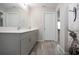 Bright bathroom features a double sink vanity and a shower with decorative curtain at 13106 Zolo Springs Cir, Riverview, FL 33579