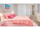 Pink bedroom with double closet, decorated with colorful decorations and light-colored carpet at 13106 Zolo Springs Cir, Riverview, FL 33579