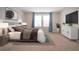 Tastefully decorated bedroom featuring a plush bed, stylish decor, and ample natural light at 13106 Zolo Springs Cir, Riverview, FL 33579