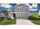 Two-story home with attached two-car garage, well-maintained lawn, and neutral color palette at 13106 Zolo Springs Cir, Riverview, FL 33579