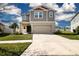 Two-story home with attached two-car garage, landscaped yard, and neutral color palette at 13106 Zolo Springs Cir, Riverview, FL 33579