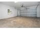 Empty garage space, showcasing the door, walls and lighting at 13106 Zolo Springs Cir, Riverview, FL 33579