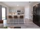 Well-lit kitchen with stainless steel appliances, light gray cabinets, and a kitchen island at 13106 Zolo Springs Cir, Riverview, FL 33579