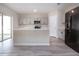 Well-lit kitchen with stainless steel appliances, light gray cabinets, and a kitchen island at 13106 Zolo Springs Cir, Riverview, FL 33579