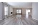 Open-concept living room with fireplace, plank flooring, and a sliding glass door for outdoor access at 13106 Zolo Springs Cir, Riverview, FL 33579