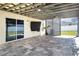Outdoor patio with a beautiful stone flooring, covered ceiling, and backyard access at 13106 Zolo Springs Cir, Riverview, FL 33579