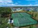 Aerial view of community tennis and basketball courts in fenced, landscaped area at 13106 Zolo Springs Cir, Riverview, FL 33579