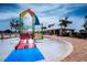 Community water park with slides, splash pad, and covered lounge area for residents at 13106 Zolo Springs Cir, Riverview, FL 33579