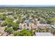Panoramic aerial view of a neighborhood with a lake, trees, and houses, showcasing the home's tranquil setting at 13216 Parkhurst Ct, Riverview, FL 33569