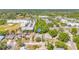 Aerial view of a neighborhood with tree-lined streets, showcasing the home's location near a park, schools and shopping at 13216 Parkhurst Ct, Riverview, FL 33569