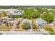 Aerial view of a neighborhood showcasing a one-story home with mature trees and lush surroundings at 13216 Parkhurst Ct, Riverview, FL 33569