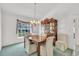 Formal dining room with wood table and chairs, and a china hutch at 13216 Parkhurst Ct, Riverview, FL 33569