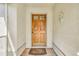Charming wooden front door with glass inserts, surrounded by a white exterior, and a welcome mat at 13216 Parkhurst Ct, Riverview, FL 33569