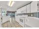 Well-lit kitchen with white cabinetry, modern appliances and tiled floor at 13216 Parkhurst Ct, Riverview, FL 33569