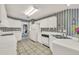 The kitchen has bright lighting, white cabinets, tile floors and modern appliances at 13216 Parkhurst Ct, Riverview, FL 33569