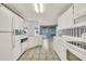 Bright kitchen with white cabinets, modern appliances and tiled floor at 13216 Parkhurst Ct, Riverview, FL 33569